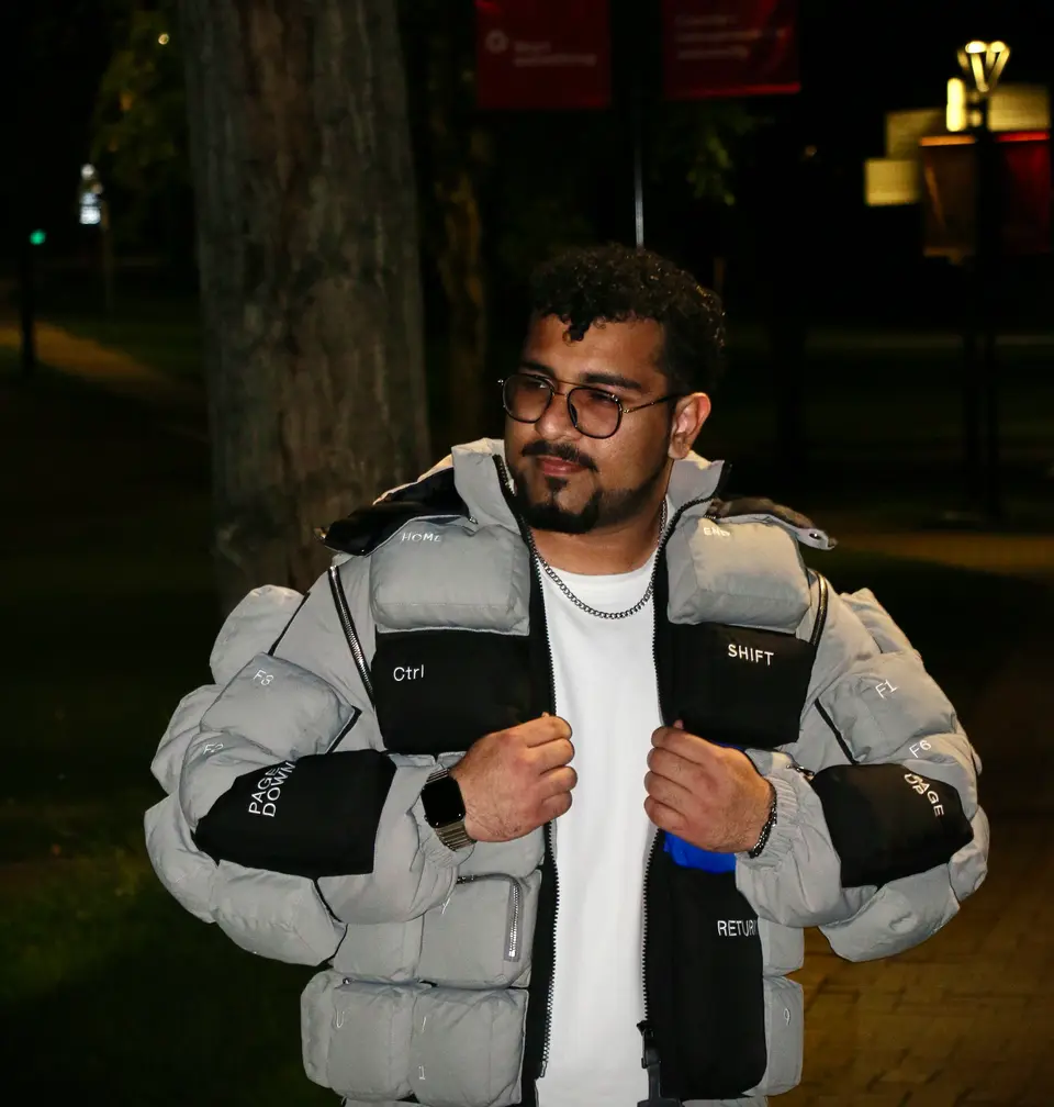 Night portrait in the keyboard jacket under warm city lights.